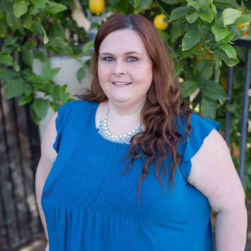 Photo of author Willow Sanders in an outdoor garden